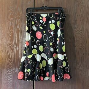 Versailles black, sheer skirt with lining and bright circles design. Size PL.
